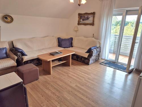 a living room with a couch and a table at Zeleni horizont 