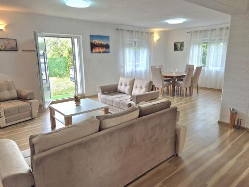 a living room with a couch and a dining room at Zeleni horizont 