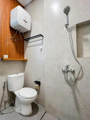 a bathroom with a shower with a toilet and a shower head at Wasabi House, Kota Baru Parahyangan in Gantungan