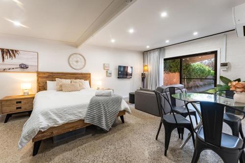 a bedroom with a bed and a table and chairs at Lakeside Bliss, Perfect Location Guesthouse in Wendouree