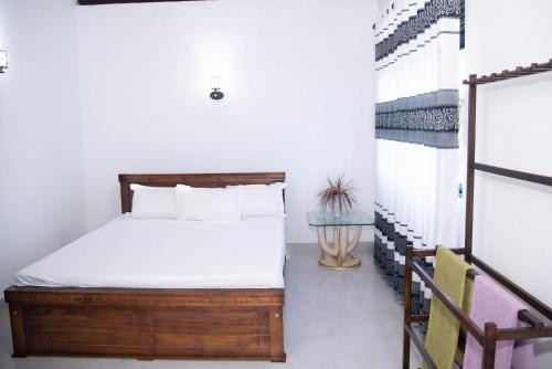 a bedroom with a bed and a staircase at White Villa Kosgoda in Kosgoda