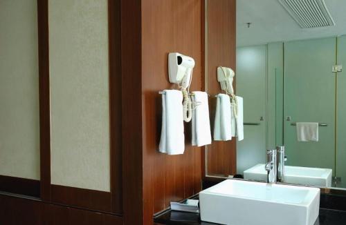 a bathroom with a sink and a mirror at Sanya Luyi Sea View Hotel in Sanya