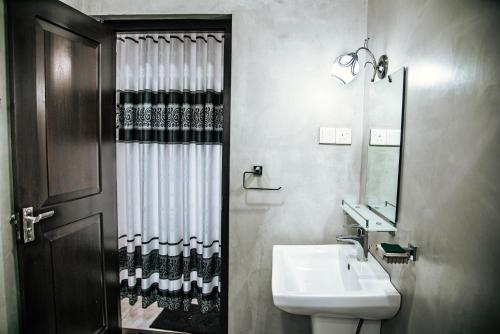 a bathroom with a sink and a mirror at White Villa Kosgoda in Kosgoda