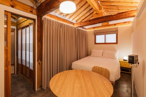 Un dormitorio con una cama y un techo de madera. en Luxury Hanok Sohomiga, en Seúl