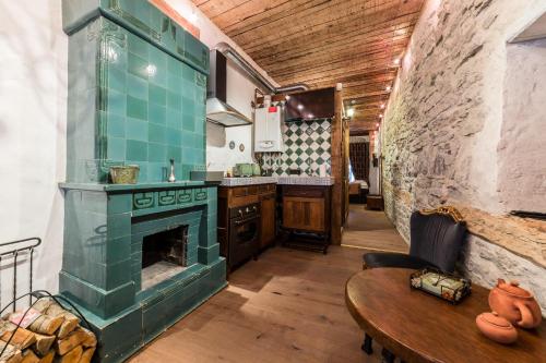 a kitchen with a green stove and a table at Viru Lux Apartment in Tallinn