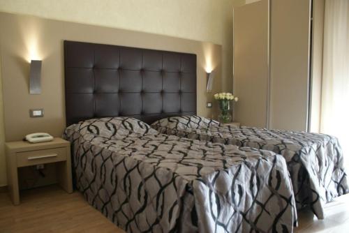 Łóżko lub łóżka w pokoju w obiekcie Hotel Michela