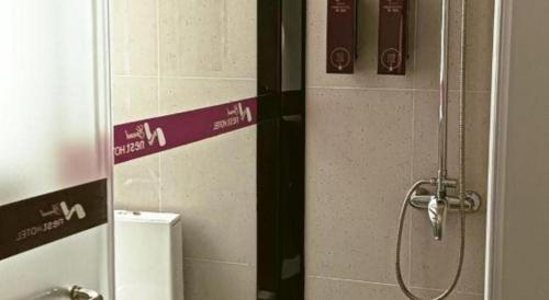a shower stall in a bathroom with a toilet at Grand Nest Hotel (Tang Jia Wan Beach) in Zhuhai