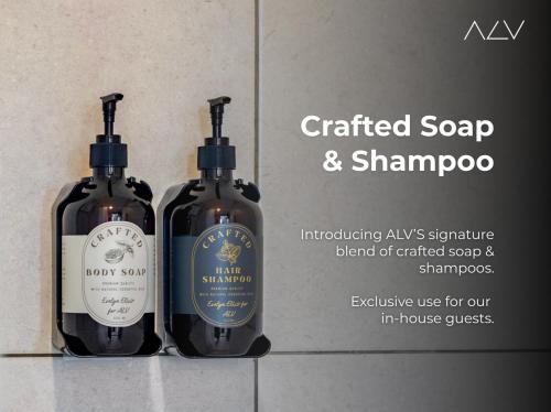 two bottles of soap and shampoo sitting on a wall at 22 Macalisterz by ALV in George Town