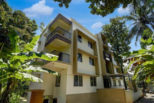 a building with balconies and trees at Super Collection O Calicut Near Calicut Medical College in Kakkayam