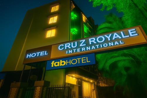 a hotel sign in front of a building at night at FabHotel Cruz Royale - Nr- Bandra West in Mumbai