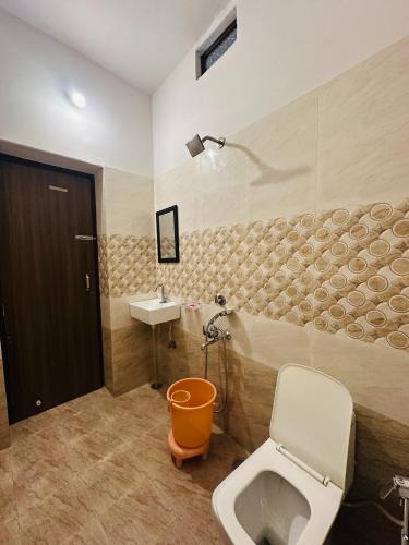 a bathroom with a toilet and a sink at Relax Inn Jaisalmer in Jaisalmer