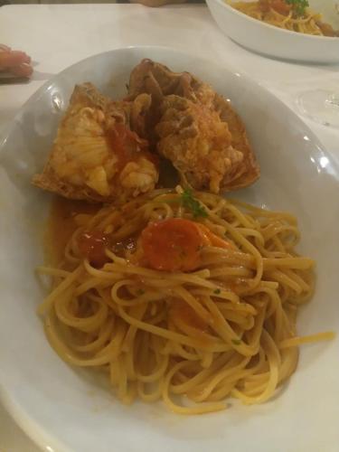 a plate of pasta with shrimp and bread on a table at Felline In Bed&Breakfast Dimora di Charme el Salento in Felline