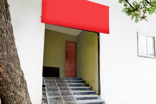 a red awning over the stairs of a building at Super Hotel O LB Nagar Metro Station Formerly Virat residency in Surūrnagar