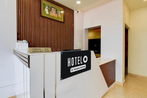 a hotel lobby with a sign on a counter at Super Hotel O Mysore Zoological Park Formerly Queens Comfort in Mysore