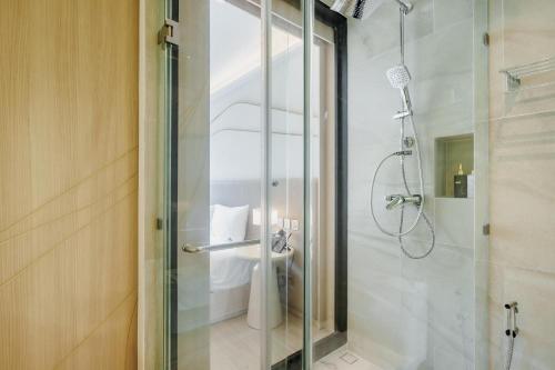 a bathroom with a glass shower with a toilet at Pool View Condo 2204 Wyndham Garden Resort in Nai Thon Beach
