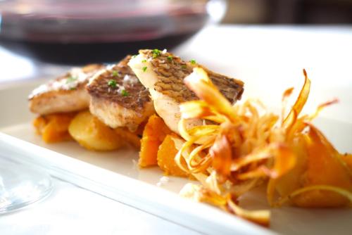a plate of food on a table with food at Hotel Balneario Valle del Jerte in Valdastillas