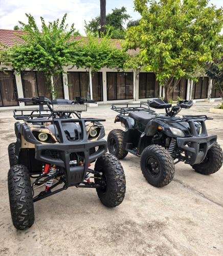 two atvs and two at bikes parked in a parking lot at Grand Suite at Mamanorms' Farm 