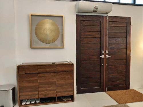 a room with a closet with a door and a mirror at Grand Suite at Mamanorms' Farm 