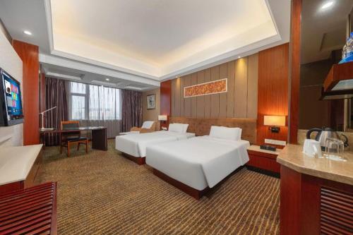 Postel nebo postele na pokoji v ubytování HX Hotel