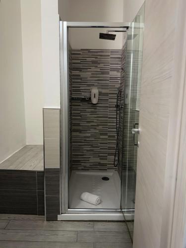 a shower with a glass door in a bathroom at Bentus B&B in Villasimius