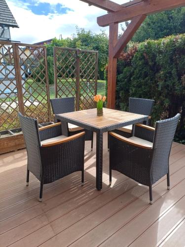 a wooden table and chairs on a wooden deck at Ferienwohnungen Birgit in Leibnitz
