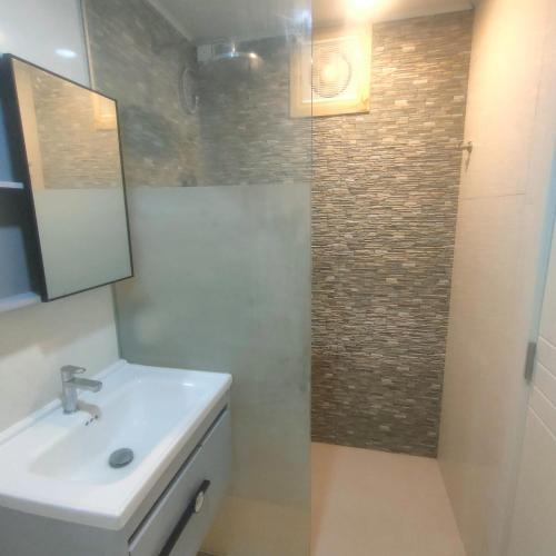 a bathroom with a sink and a shower with a mirror at ROYAL Village Dhangethi Maldives in Male City