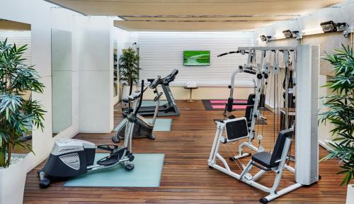 a gym with treadmills and elliptical machines at Sercotel Coliseo in Bilbao