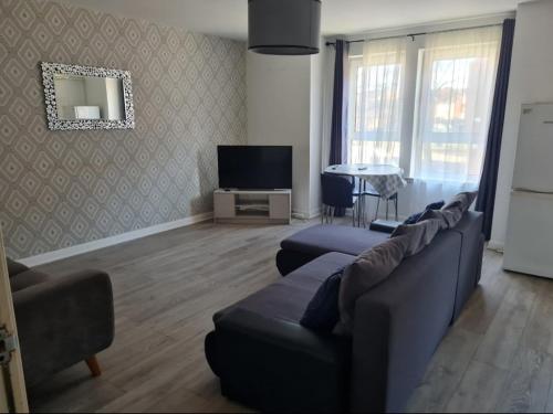 a living room with a couch and a tv at City, Celtic park & Emirates Stadium Apartment, for families or age over 23 in Glasgow