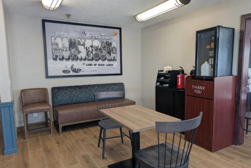 a waiting room with a table and chairs at Super 8 by Wyndham Perham in Perham