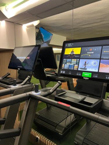 a gym with two monitors and a treadmill at WX Hotel in Bratislava