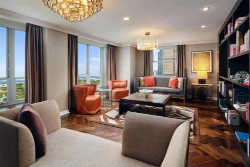 a living room with furniture and a chandelier at Hilton Chicago in Chicago