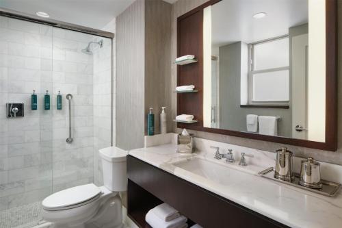 a bathroom with a sink and a toilet and a mirror at Hilton Chicago in Chicago