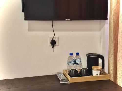 a counter with two bottles of water on a shelf at CAO Ella in Ella