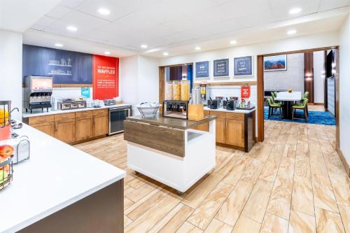 a large kitchen with a counter and a restaurant at Hampton Inn & Suites Silverthorne in Silverthorne