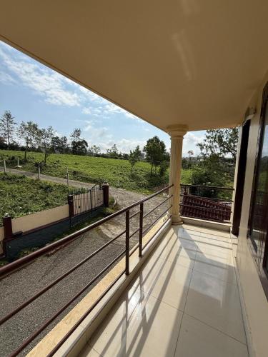 a balcony with a view of a field at Biglaand Dew Castle in Pīrmed