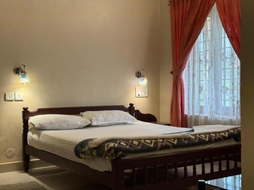 a bedroom with a bed with a large window at Biglaand Dew Castle in Pīrmed