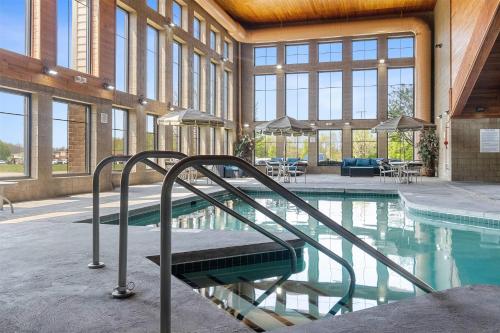 a swimming pool with a stairway in a building at AmericInn by Wyndham Green Bay East in Green Bay
