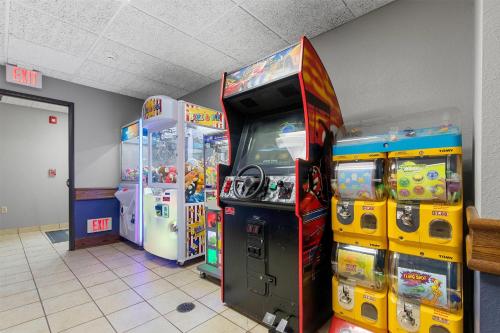 a video game arcade with two arcade machines in a room at AmericInn by Wyndham Green Bay East in Green Bay