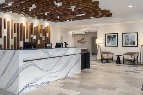 a lobby with a marble counter and chairs at Doubletree By Hilton Wilmington, Nc in Wilmington