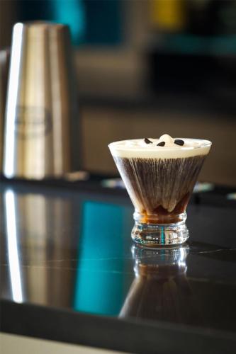 a cup of coffee sitting on top of a table at Doubletree By Hilton Wilmington, Nc in Wilmington