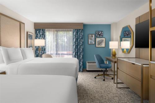 a hotel room with a bed and a desk at Doubletree By Hilton Wilmington, Nc in Wilmington