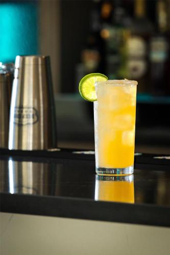 a drink sitting on a table with a lime on it at Doubletree By Hilton Wilmington, Nc in Wilmington