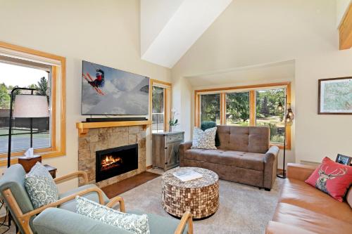 a living room with a fireplace and a tv at 470 Homestead Unit 13 townhouse in Edwards