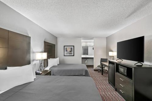 a hotel room with two beds and a flat screen tv at Econo Lodge Helen in Helen