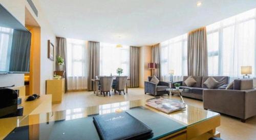 a living room with a couch and a table at The Bauhinia in Shenzhen