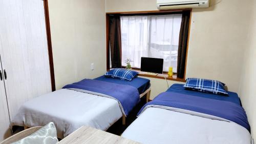 Postel nebo postele na pokoji v ubytování Kokusaigakusya Ozukikaikan - Vacation STAY 18798