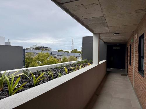 a balcony of a building with plants on it at Urban Escape - Le Jardin Unit 301 in George