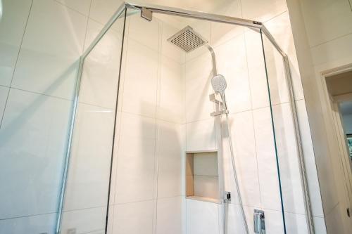 a shower with a glass door in a bathroom at Silver Birches Holiday Village - Unit 4 in Bright