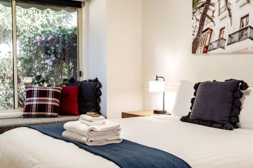 a bedroom with a bed with towels on it at Silver Birches Holiday Village - Unit 4 in Bright