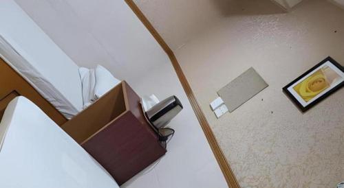 a bedroom with a box on the floor and a lamp at New Mong Kok Guest House in Hong Kong
